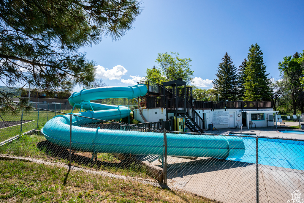Community pool featuring a water slide