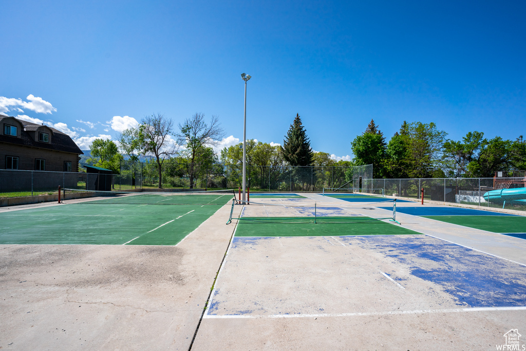 View of tennis court featuring community basketball court