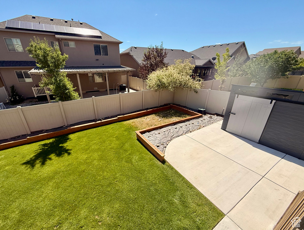 Fenced backyard with a patio and a residential view
