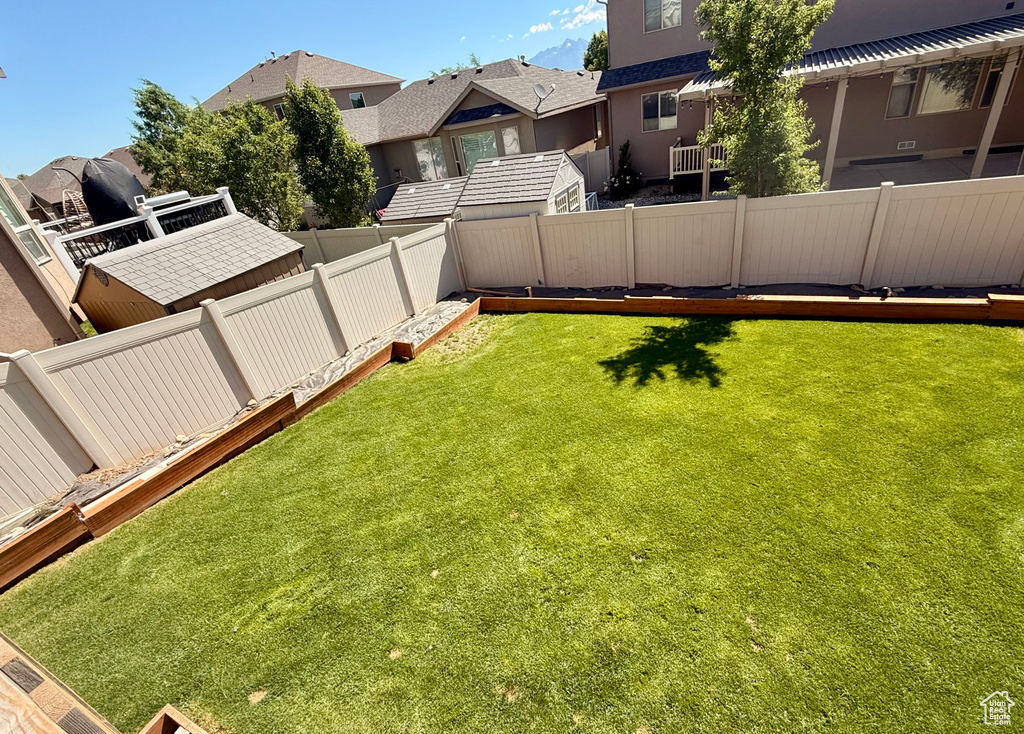 Fenced backyard featuring a residential view