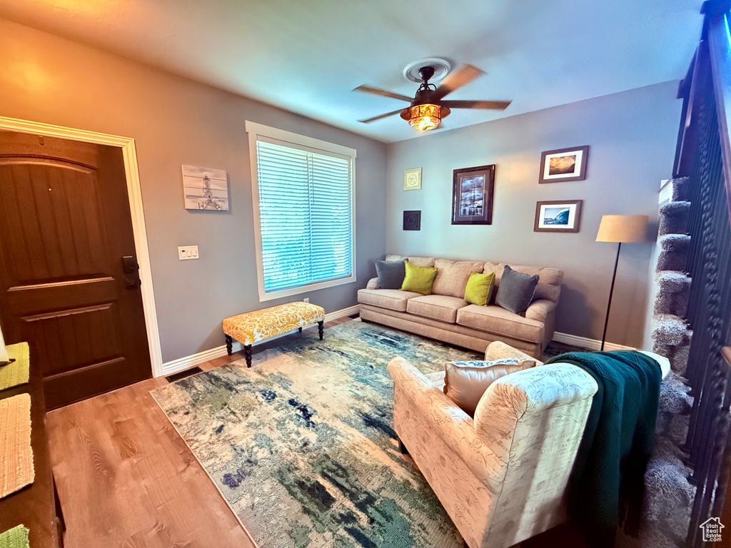 Living room with ceiling fan and wood finished floors