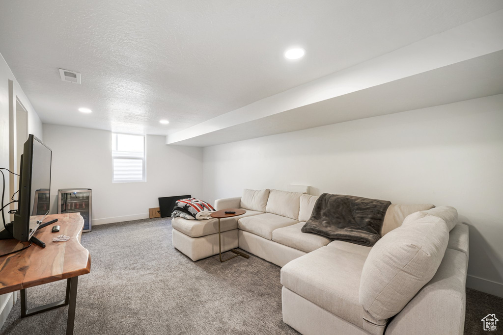 Carpeted living area featuring baseboards and recessed lighting