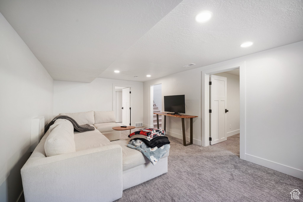 Living room with recessed lighting, carpet, and a textured ceiling