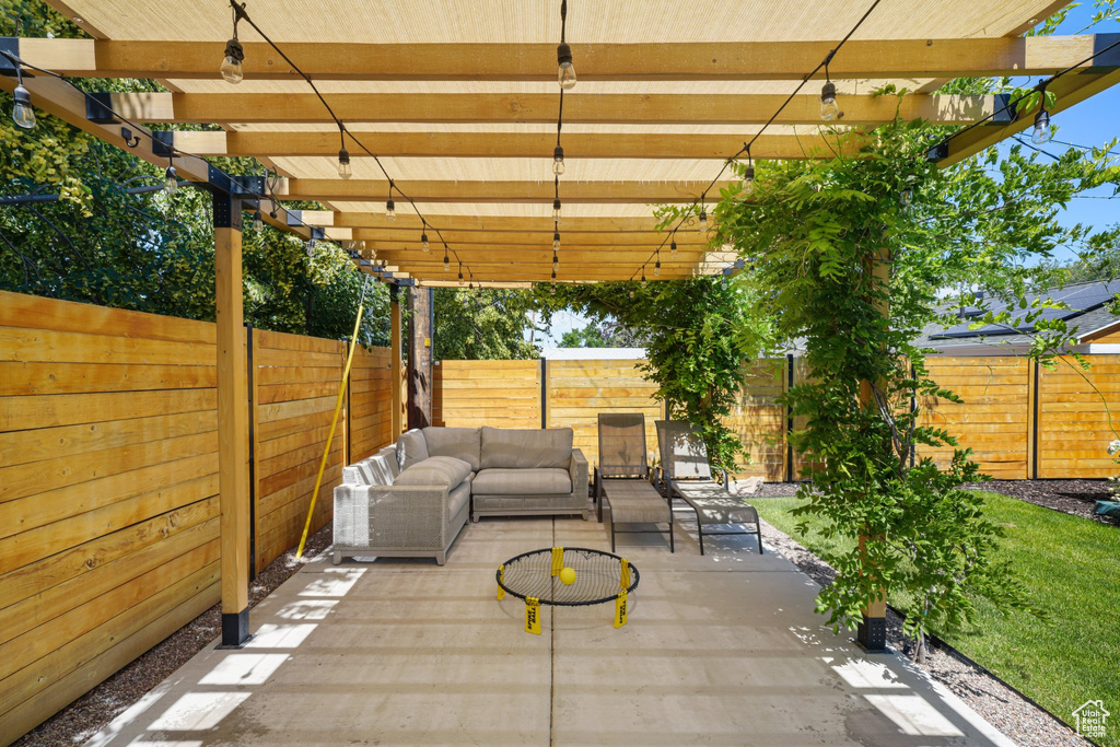 Fenced backyard with a pergola, outdoor lounge area, and a patio area
