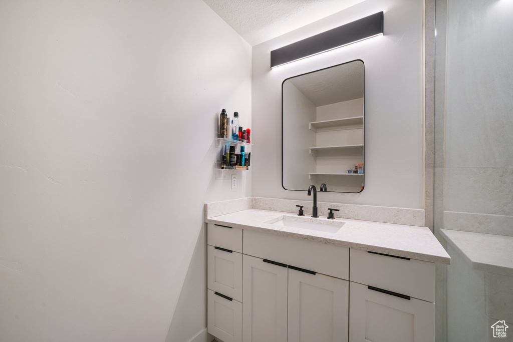 Bathroom featuring vanity and a textured ceiling