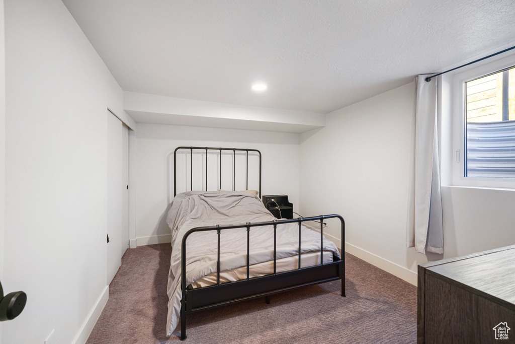 Bedroom featuring dark carpet and recessed lighting