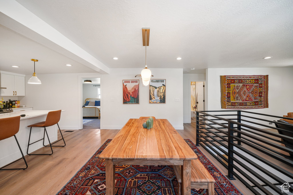 Dining space featuring light wood finished floors and recessed lighting
