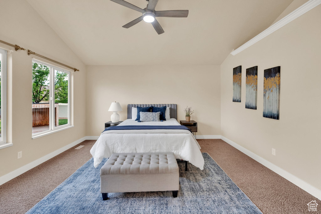 Bedroom with lofted ceiling, carpet floors, and a ceiling fan