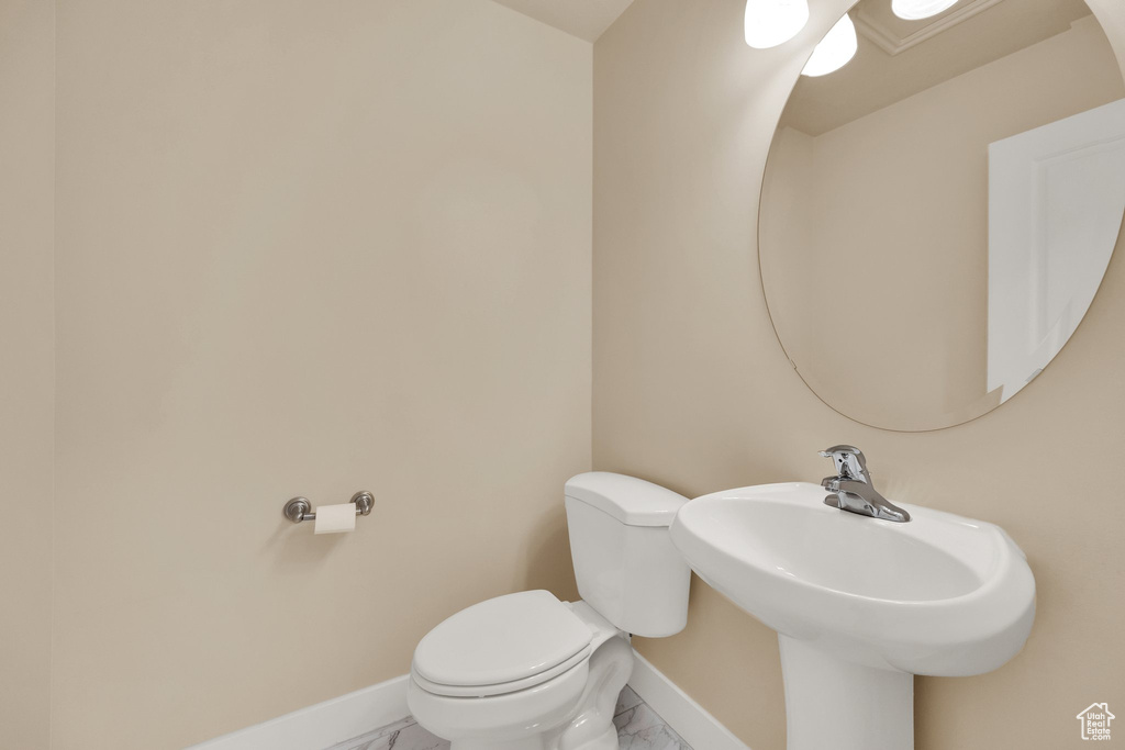Bathroom with marble finish flooring and toilet