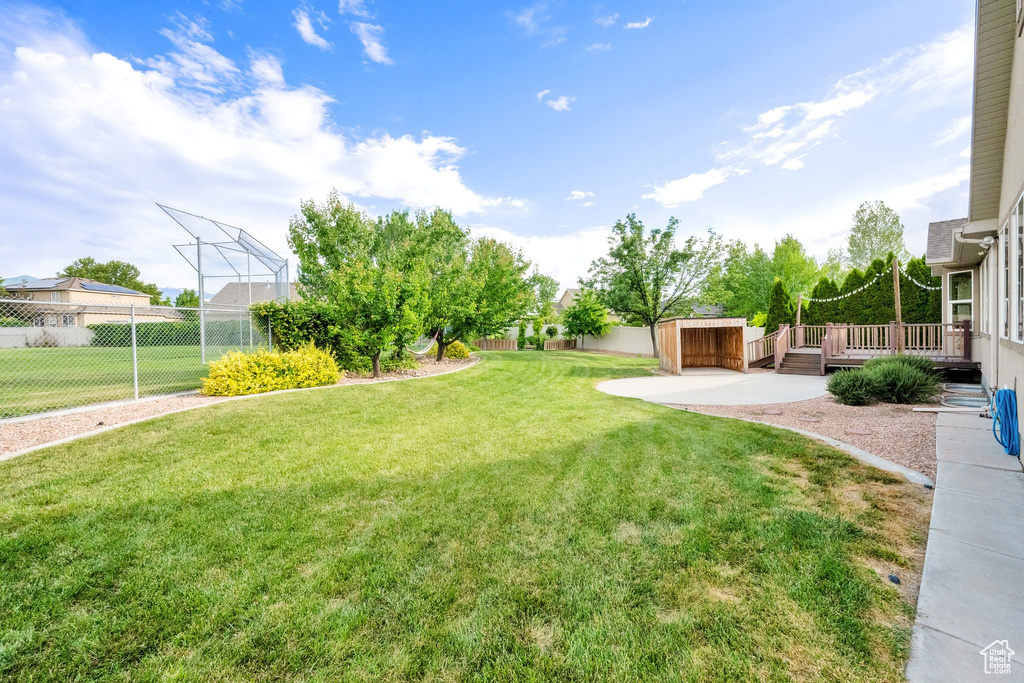 Fenced backyard featuring a wooden deck