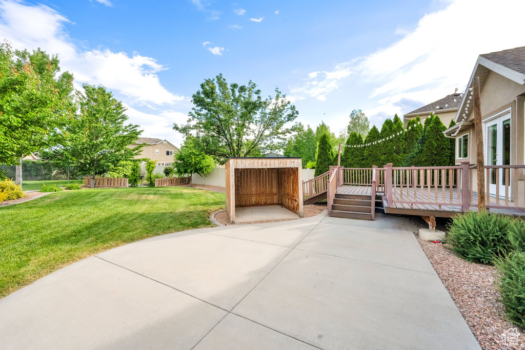 View of patio / terrace with a deck and an outbuilding