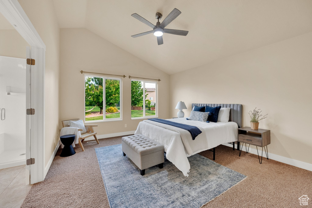 Carpeted bedroom with high vaulted ceiling and ceiling fan
