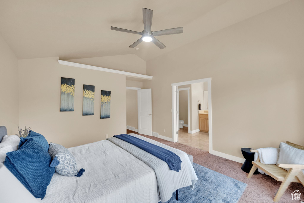 Bedroom featuring light carpet, a ceiling fan, high vaulted ceiling, and ensuite bathroom
