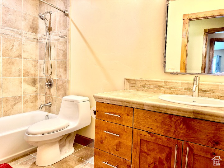 Full bathroom featuring vanity, tub / shower combination, and tile patterned flooring