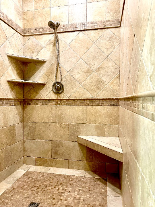 Full bath featuring tiled shower