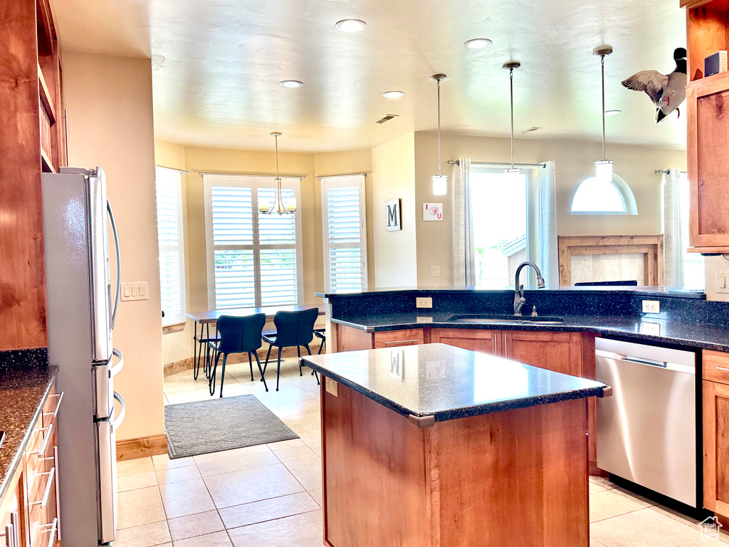 Kitchen featuring stainless steel appliances, light tile patterned flooring, healthy amount of natural light, decorative light fixtures, and recessed lighting