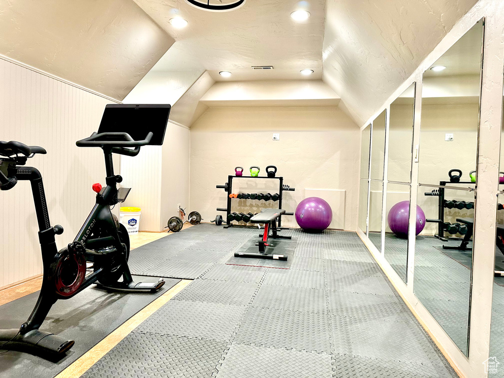 Exercise room with recessed lighting and vaulted ceiling