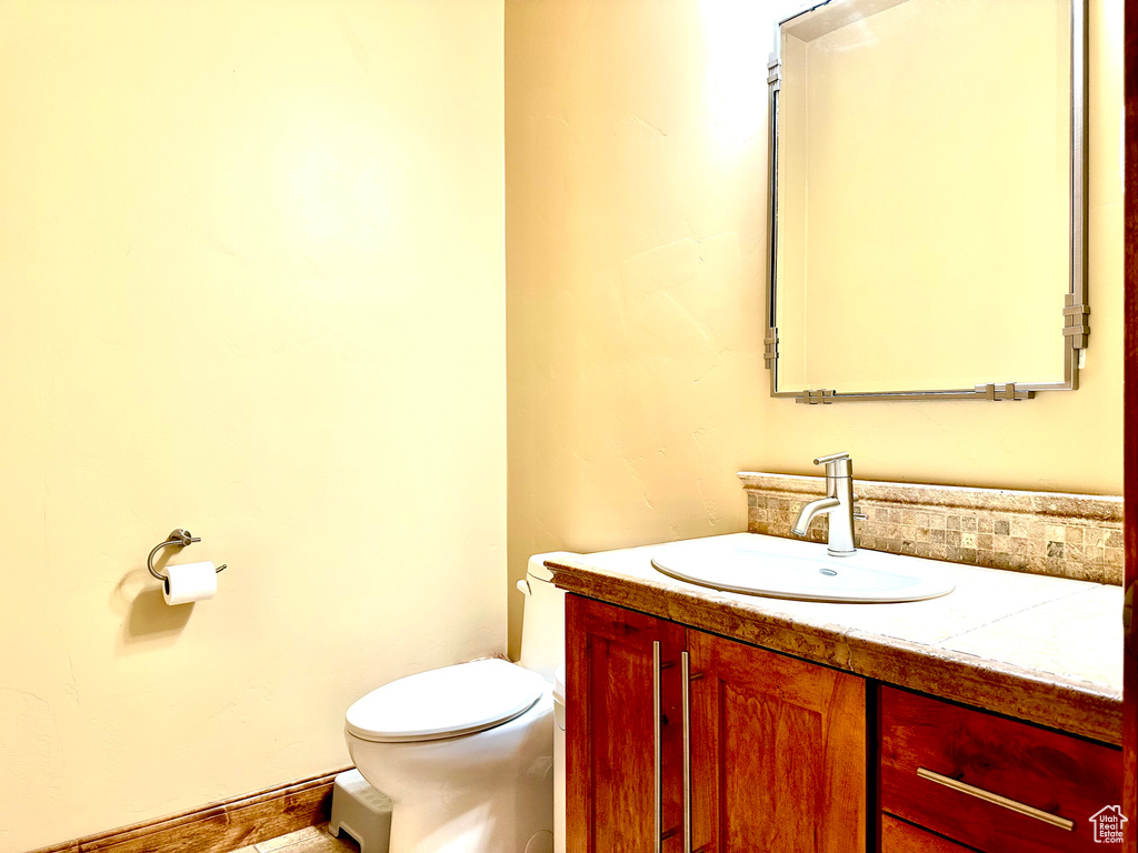 Half bathroom with toilet and vanity