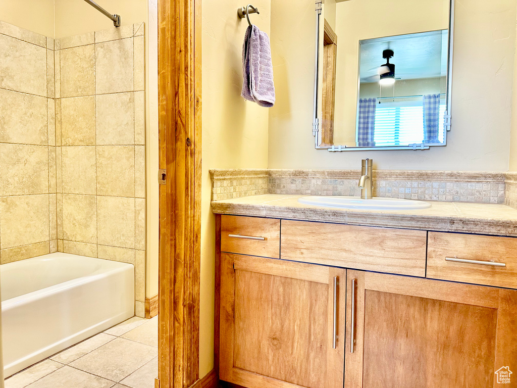 Full bathroom with tile patterned flooring, vanity, shower / bath combination, and ceiling fan