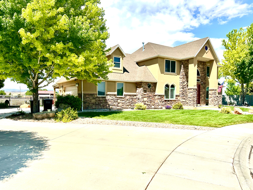 View of front of property with stucco siding and stone siding