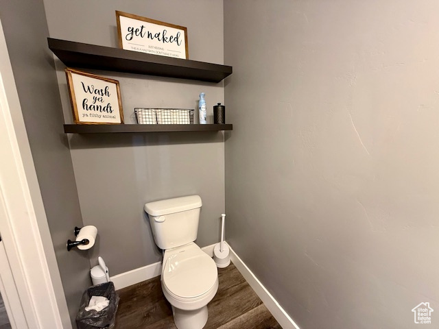 Bathroom with wood finished floors and baseboards