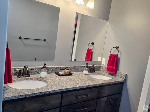 Full bath with double vanity and baseboards
