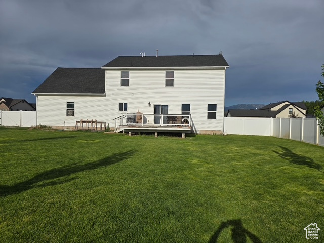 Rear view of property with a wooden deck