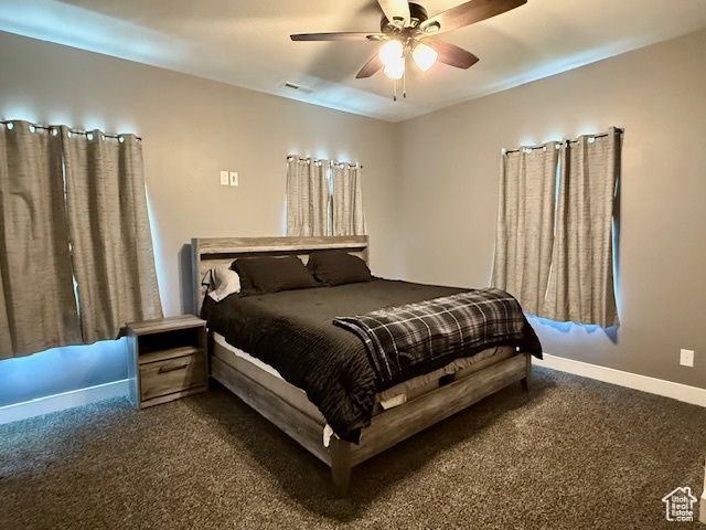 Carpeted bedroom with baseboards and ceiling fan