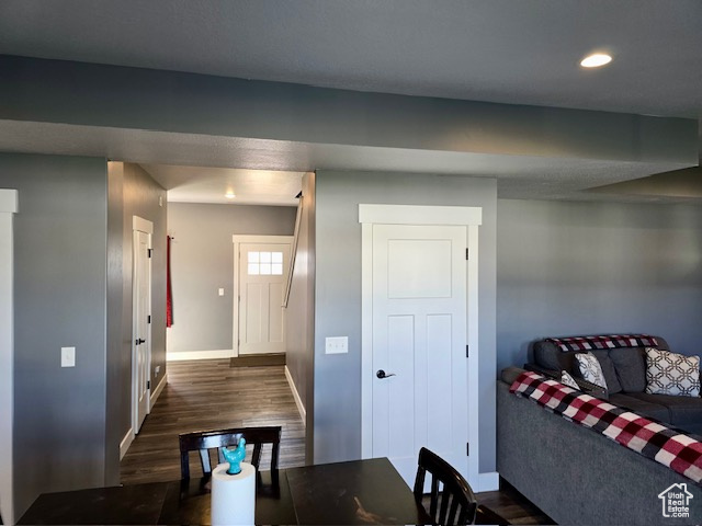 Dining area with dark wood finished floors and recessed lighting