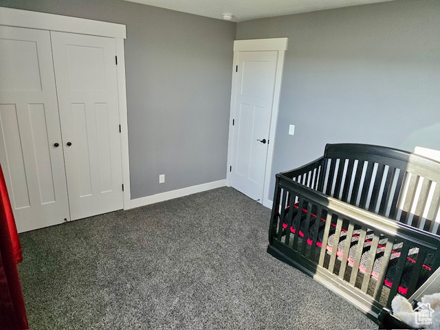 Bedroom featuring carpet flooring, a crib, and a closet