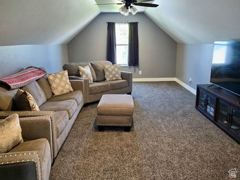 Living room with carpet, a textured ceiling, lofted ceiling, and ceiling fan