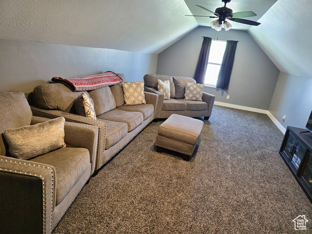 Living area featuring carpet flooring, vaulted ceiling, a textured ceiling, and a ceiling fan
