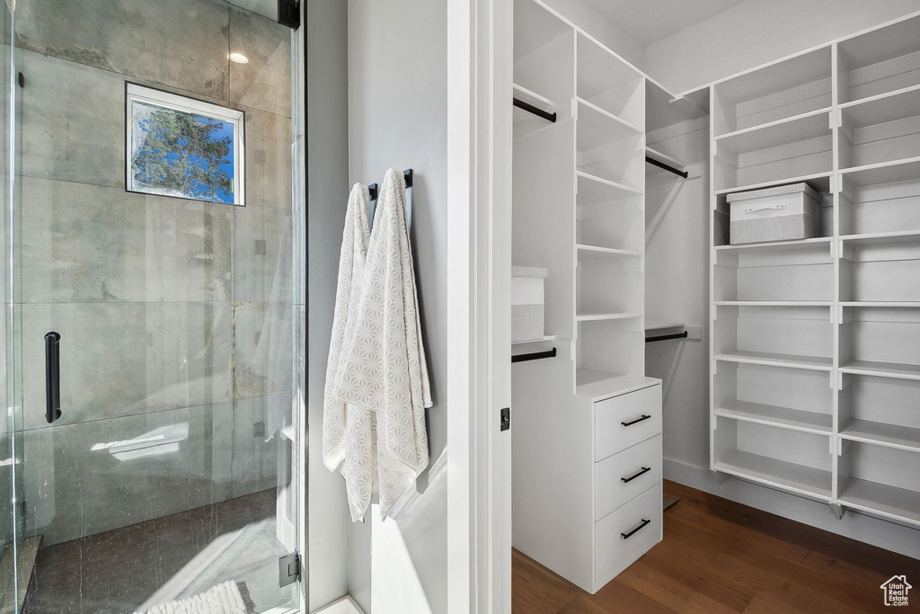 Walk in closet featuring wood finished floors