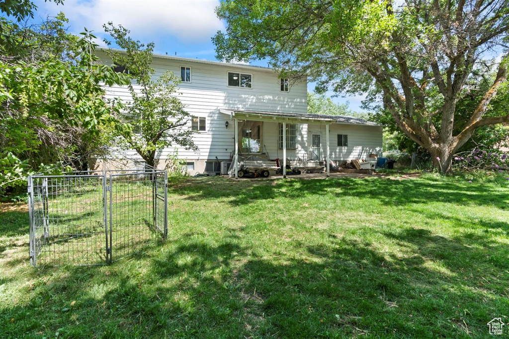 Back of property featuring a lawn