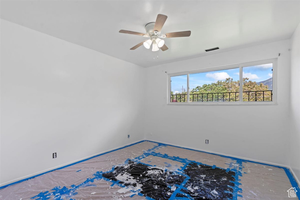 Empty room with a ceiling fan and baseboards