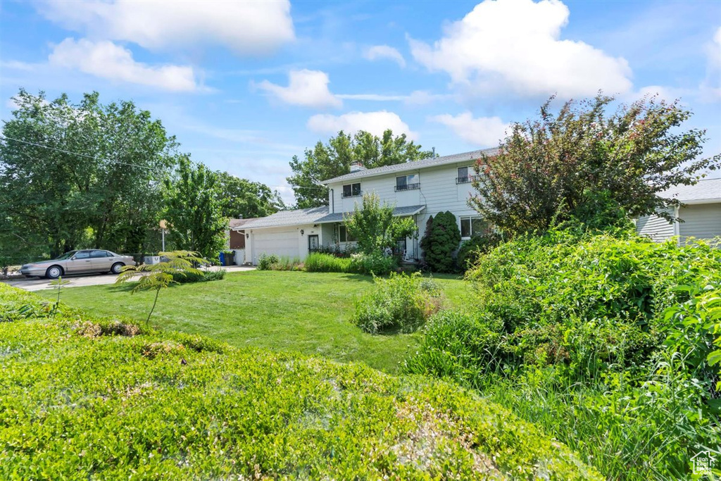View of grassy yard with an attached garage