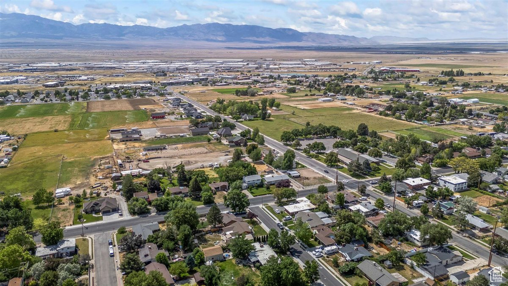 Aerial overview of property\'s location with a mountain backdrop and nearby suburban area