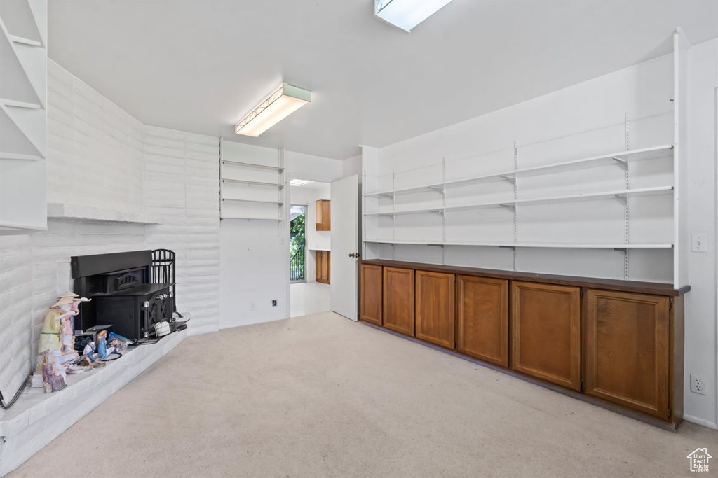 Basement with carpet and a wood stove