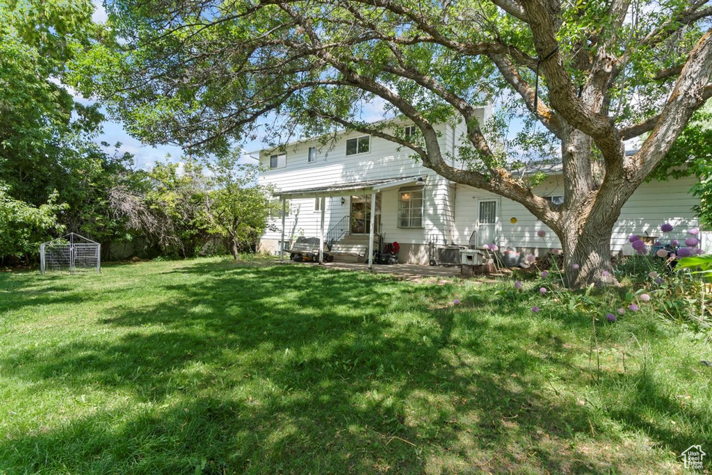 Rear view of property featuring a yard