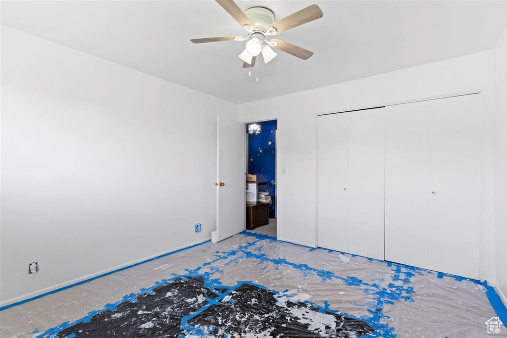Unfurnished bedroom featuring a closet and a ceiling fan