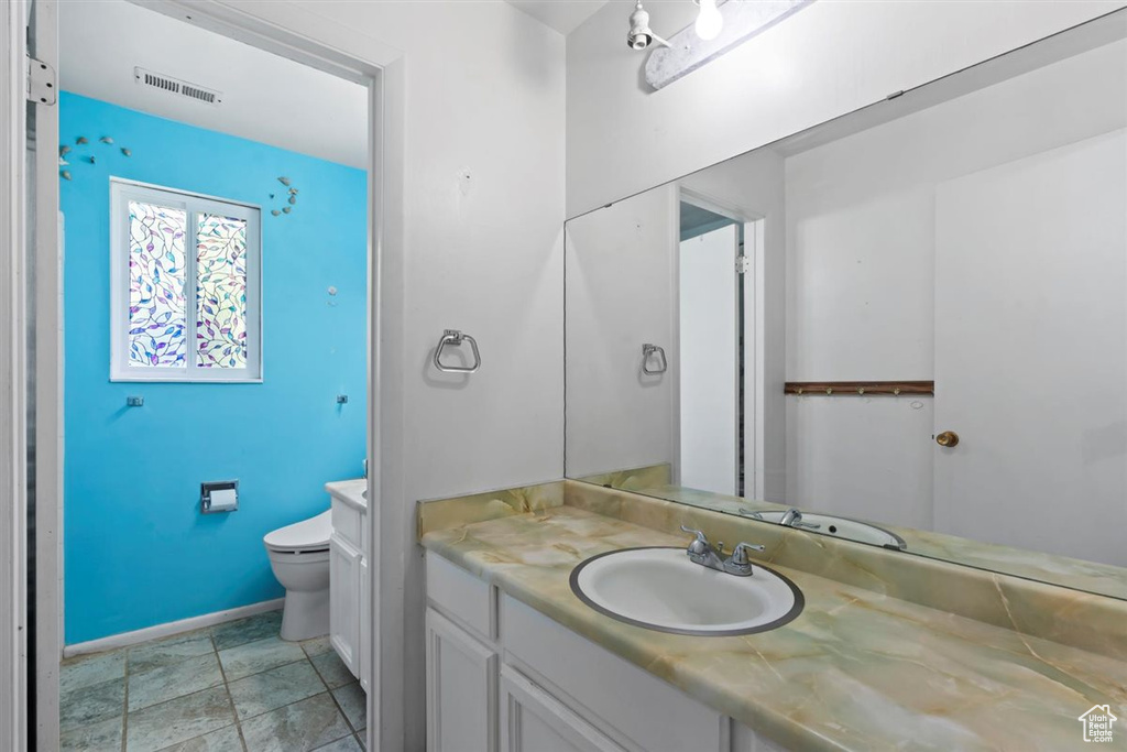 Bathroom featuring vanity and stone finish floors
