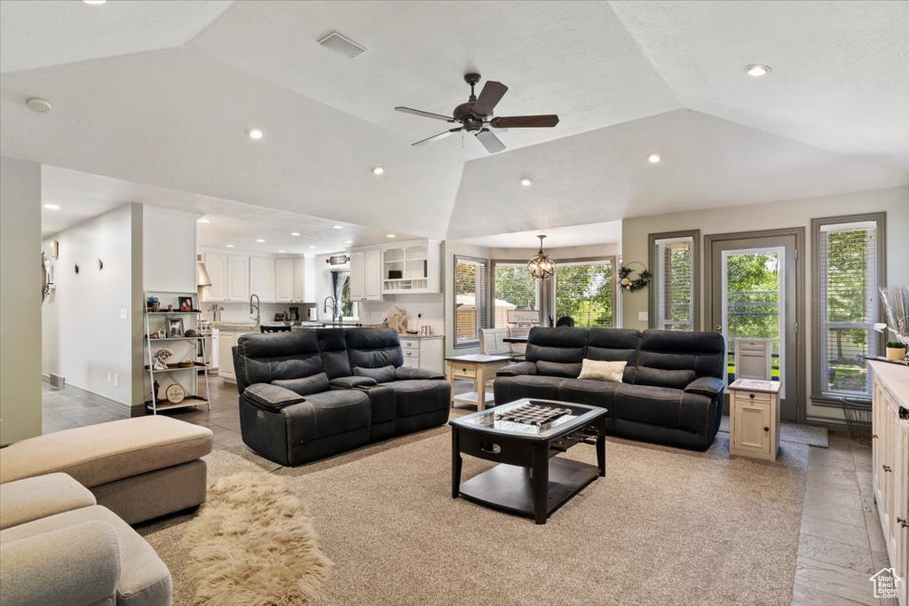 Living area featuring lofted ceiling, recessed lighting, and ceiling fan