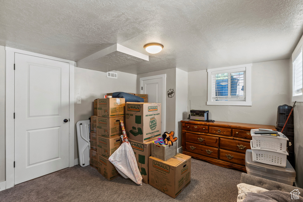 Carpeted bedroom with a textured ceiling