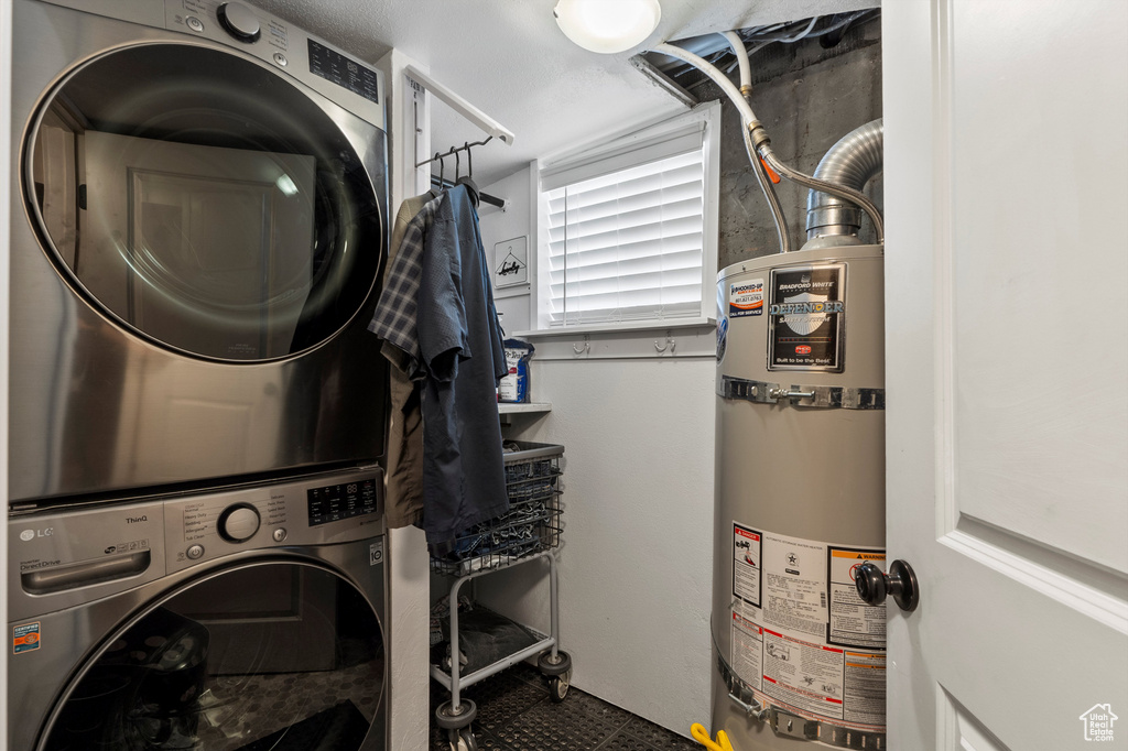 Laundry area featuring water heater and estacked washer and dryer