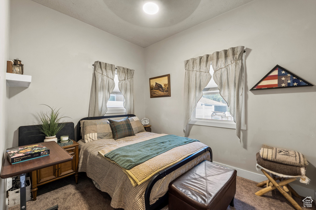Carpeted bedroom featuring baseboards