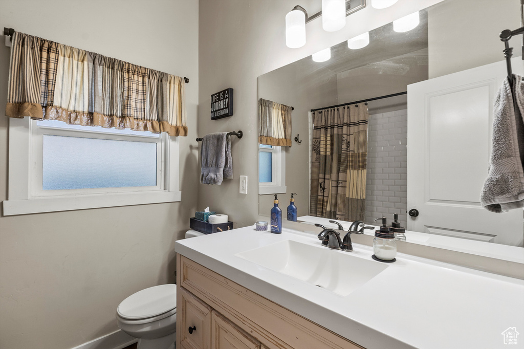 Full bathroom with vanity and curtained shower