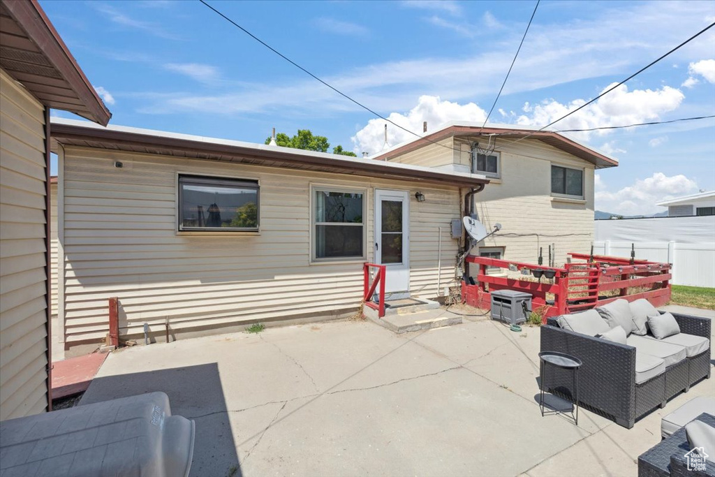Back of house featuring an outdoor living space, a patio, and entry steps