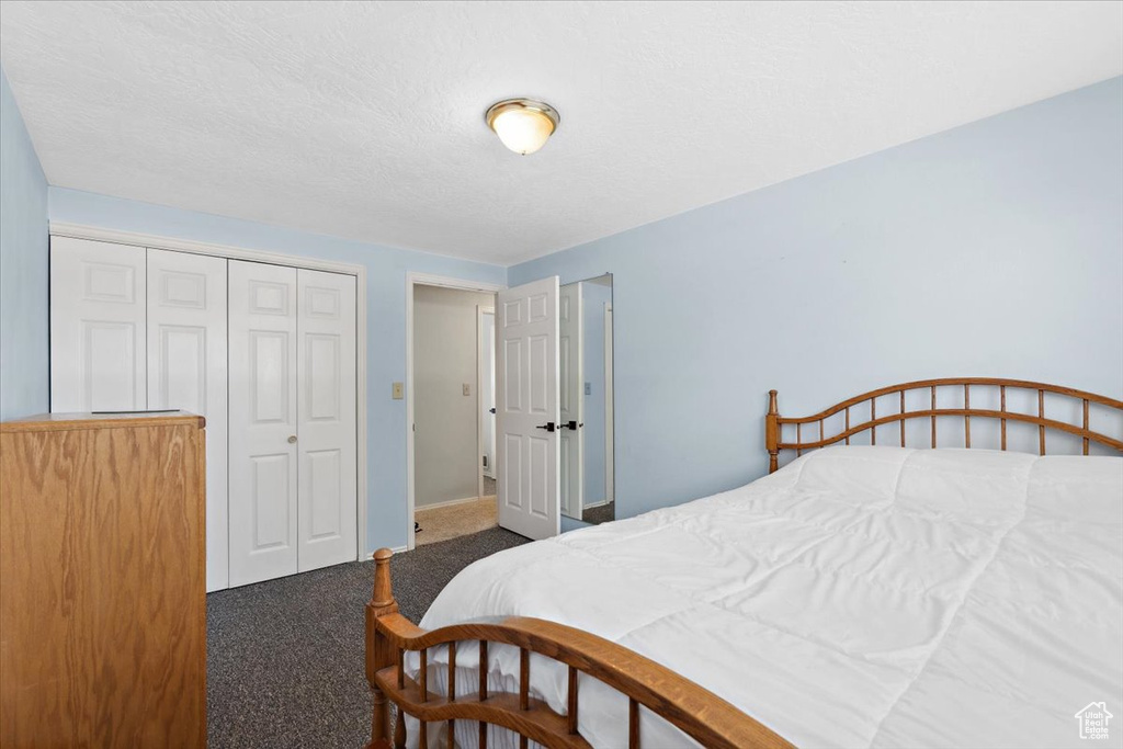 Bedroom with carpet and a closet