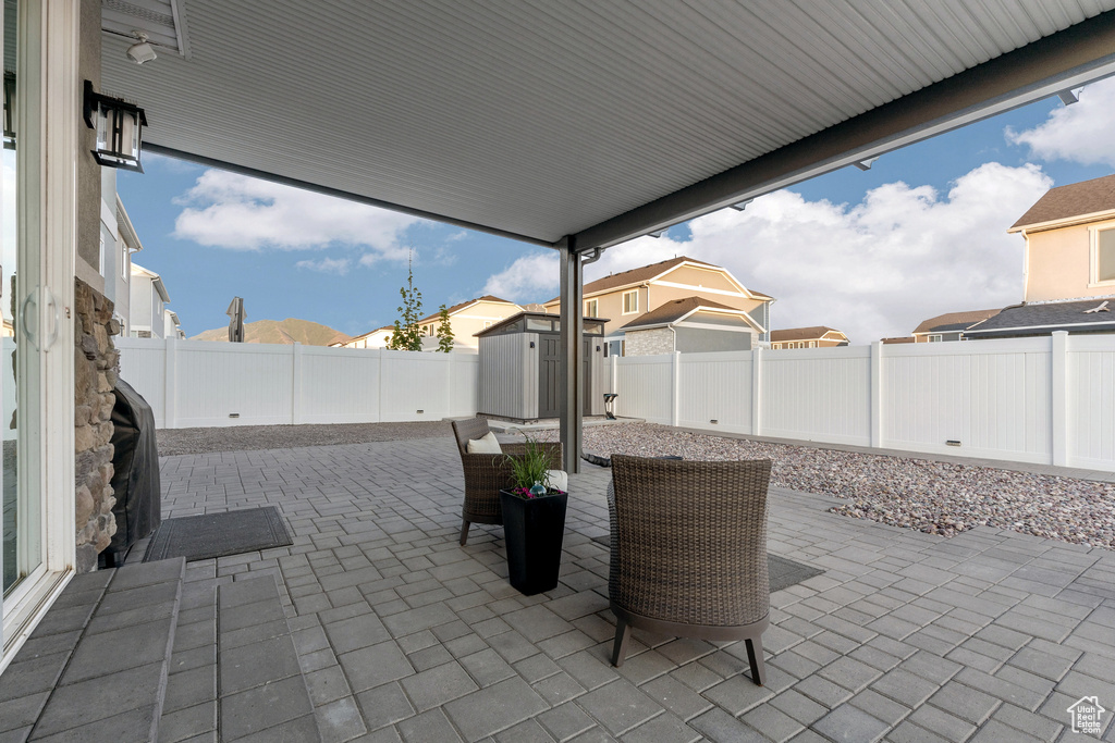 Fenced backyard featuring a patio area and a residential view