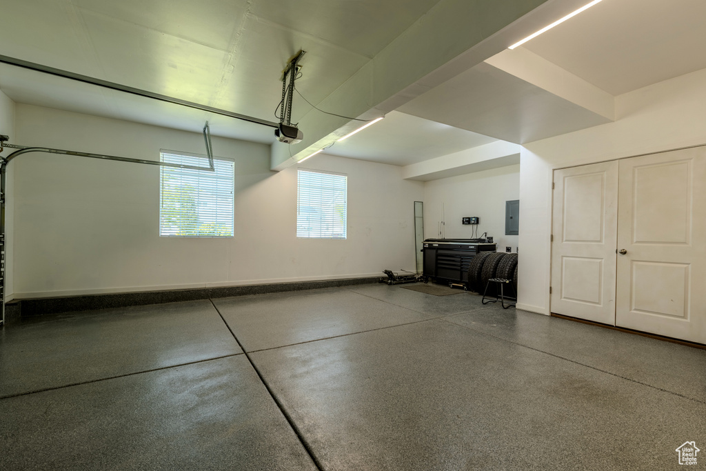 Garage featuring electric panel and a garage door opener